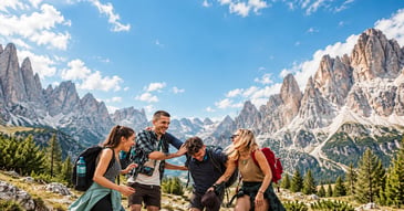 A group of incentive travel participants hiking together in the mountains during a team adventure experience.