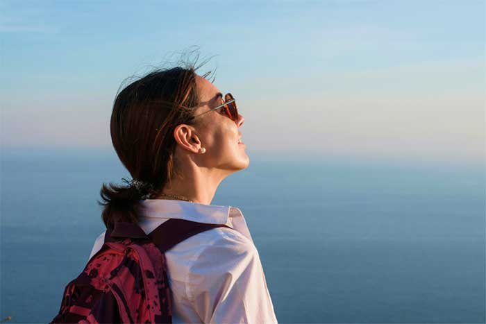 Traveler with backpack overlooking sunset by the ocean-5B8-0-1 Traveler with backpack overlooking sunset by the ocean-5B8-0-1